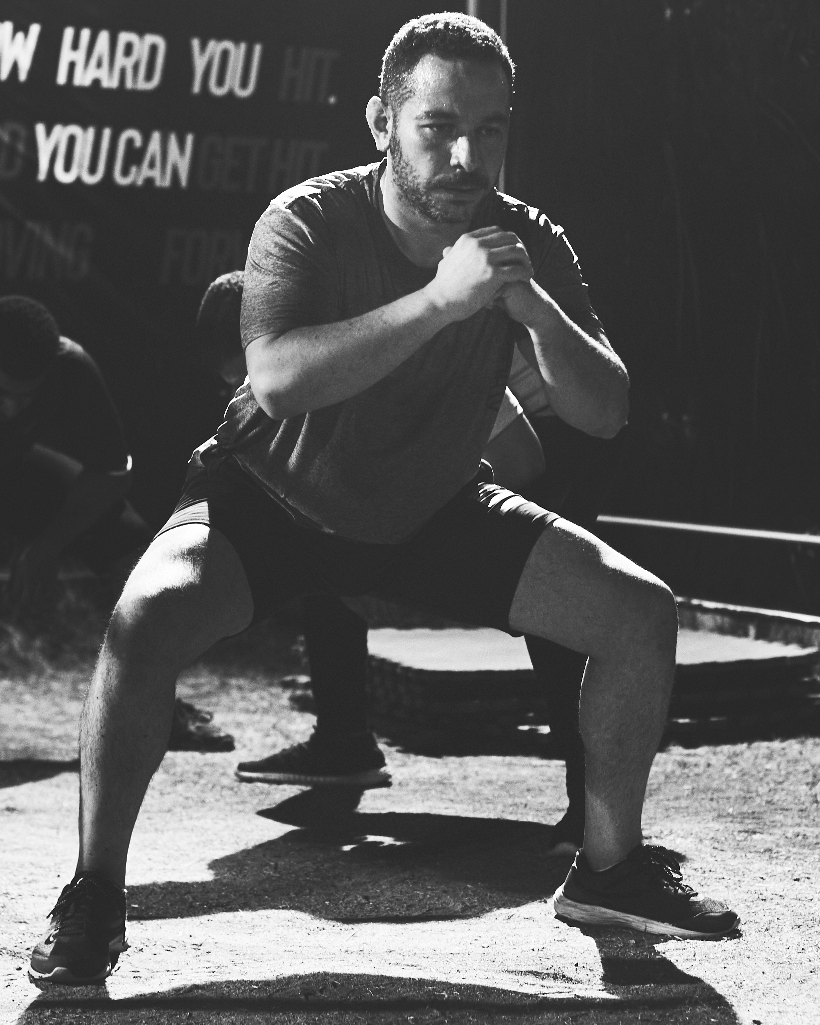 Athlete holding a deep squat during a night session